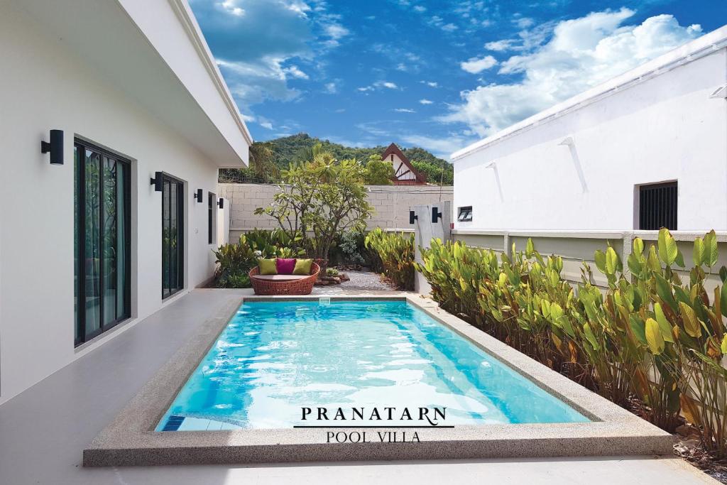 a swimming pool in the backyard of a house at Pranatarn Pool Villa Endless Summer in Pran Buri