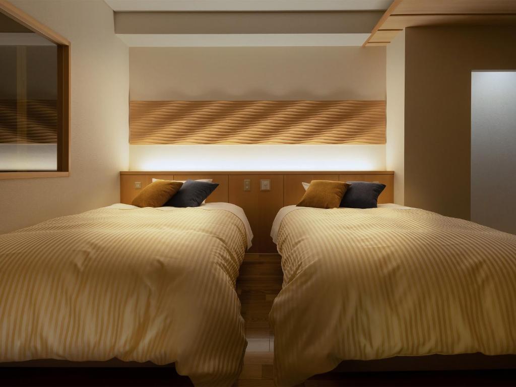 Postel nebo postele na pokoji v ubytování Tendo Hotel