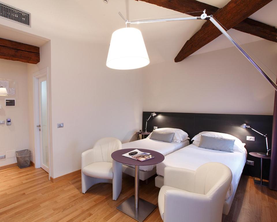 Postel nebo postele na pokoji v ubytování Hotel Annunziata