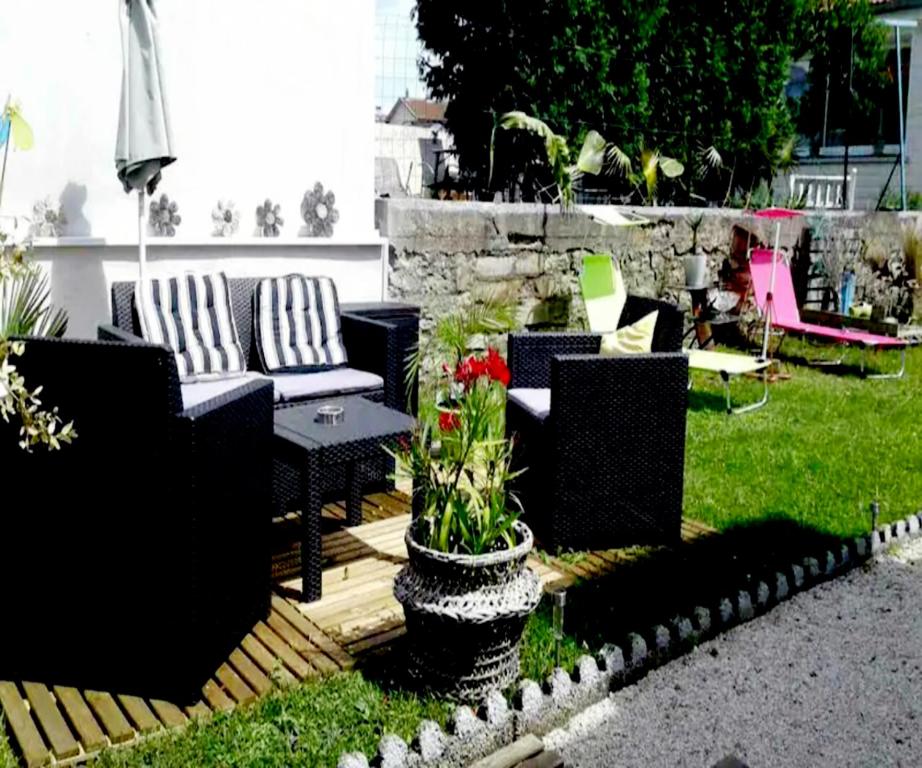 un patio con sofás, mesa y sillas en blue room, spa, kitchenette, en Chaumont