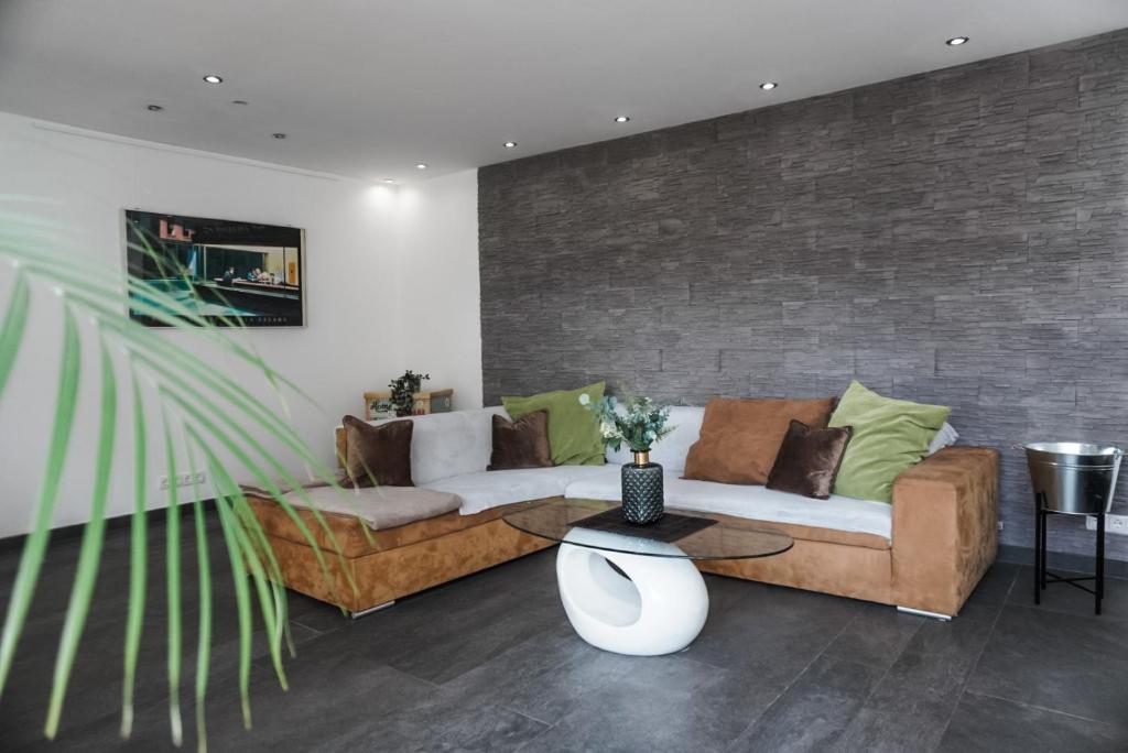 sala de estar con sofá y mesa en Neu gebautes Apartment mit Sonnenterasse in der Nähe vom Siebengebirge & Bonn en Königswinter