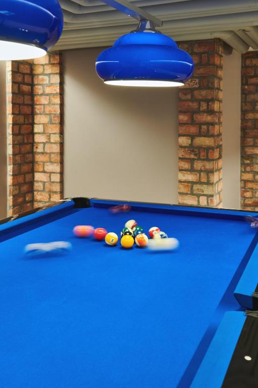 a blue pool table with balls on top of it at SCHLOSS Zermatt - CBD & Adaptogenic Spa and Sport Hotel in Zermatt