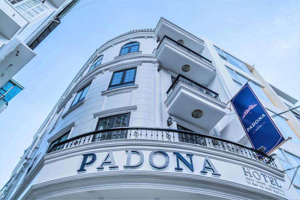 a white building with a balcony on top of it at Padona Hotel in Da Lat