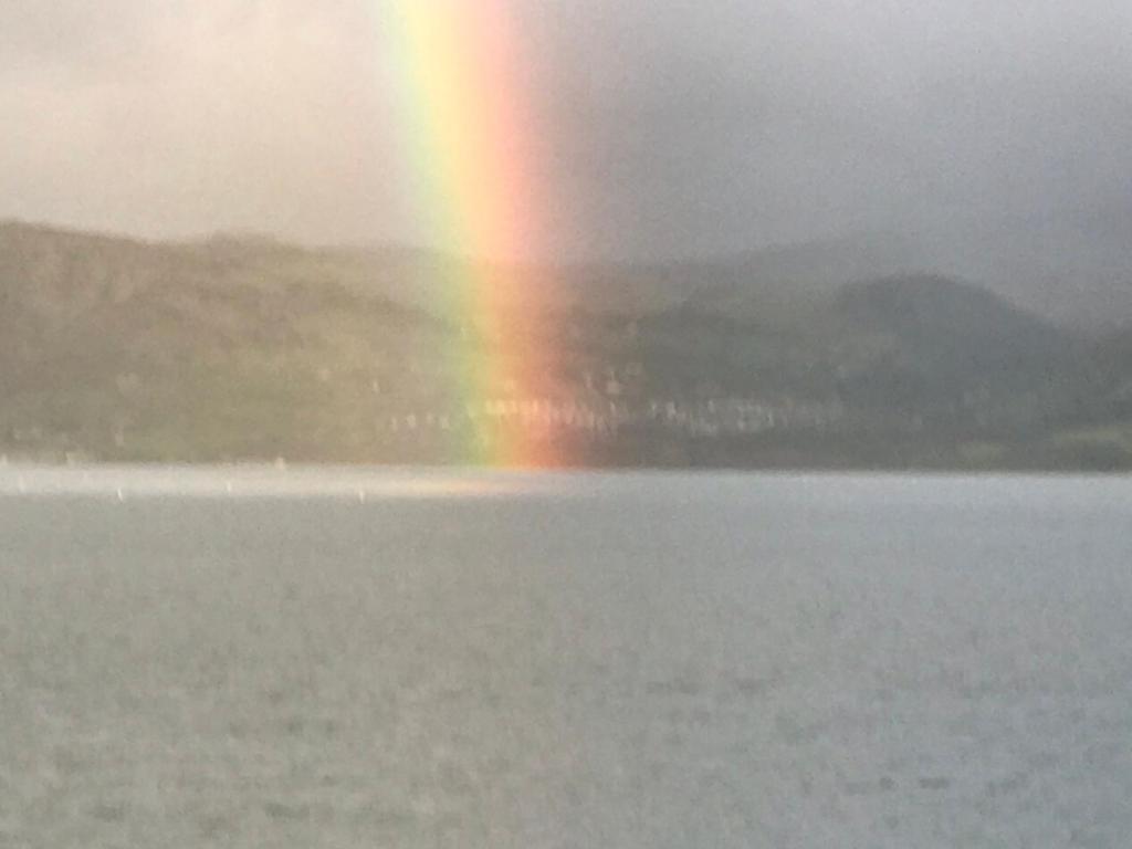 a rainbow over a body of water with a rainbow at Church Street Homestay in Beaumaris