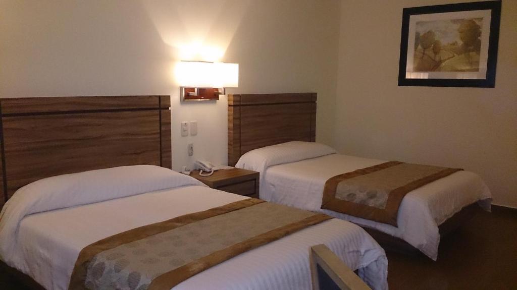 Postel nebo postele na pokoji v ubytování Hotel Oliver Inn - Business Class