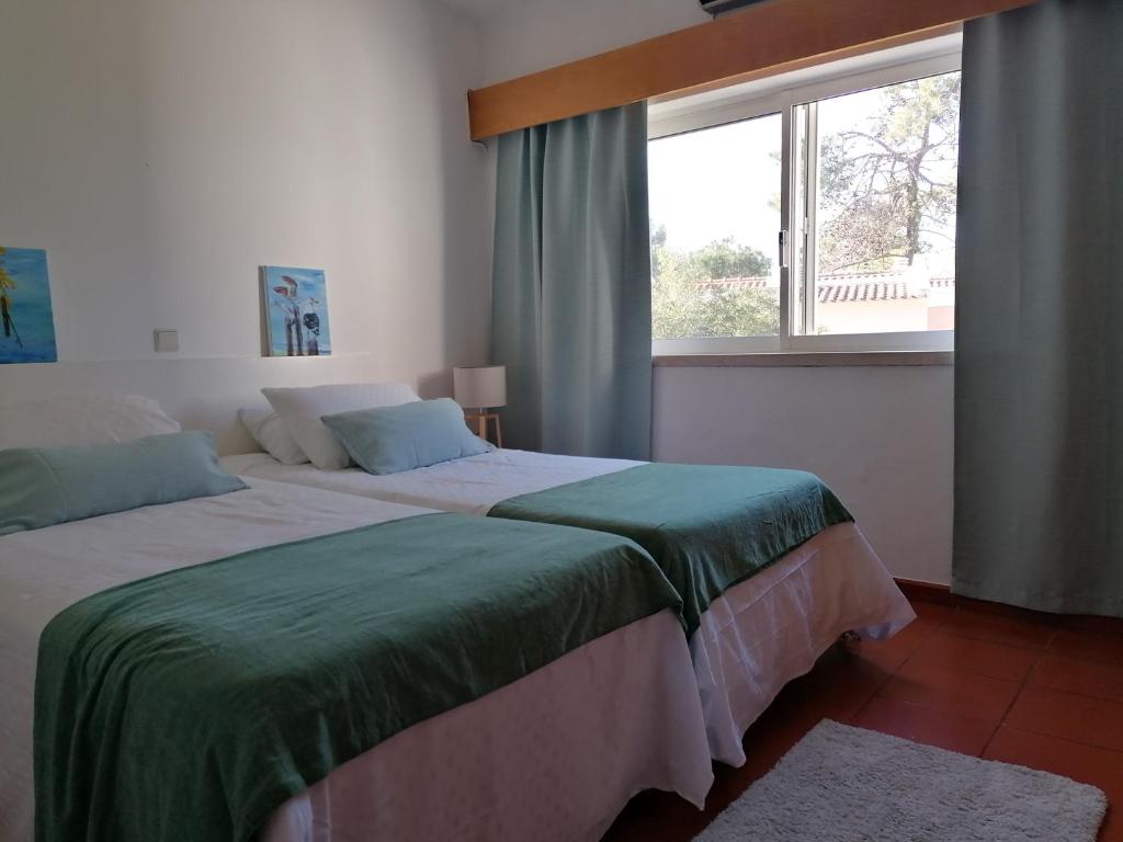 1 dormitorio con 2 camas y ventana en Quinta do Lago Villa and Golf, en Quinta do Lago