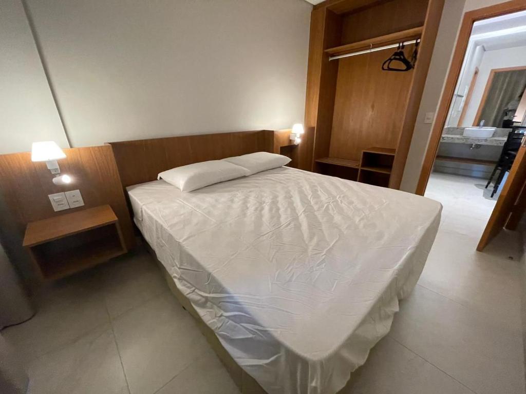 a bedroom with a bed with a white comforter at Salinas Exclusive resort in Salinópolis