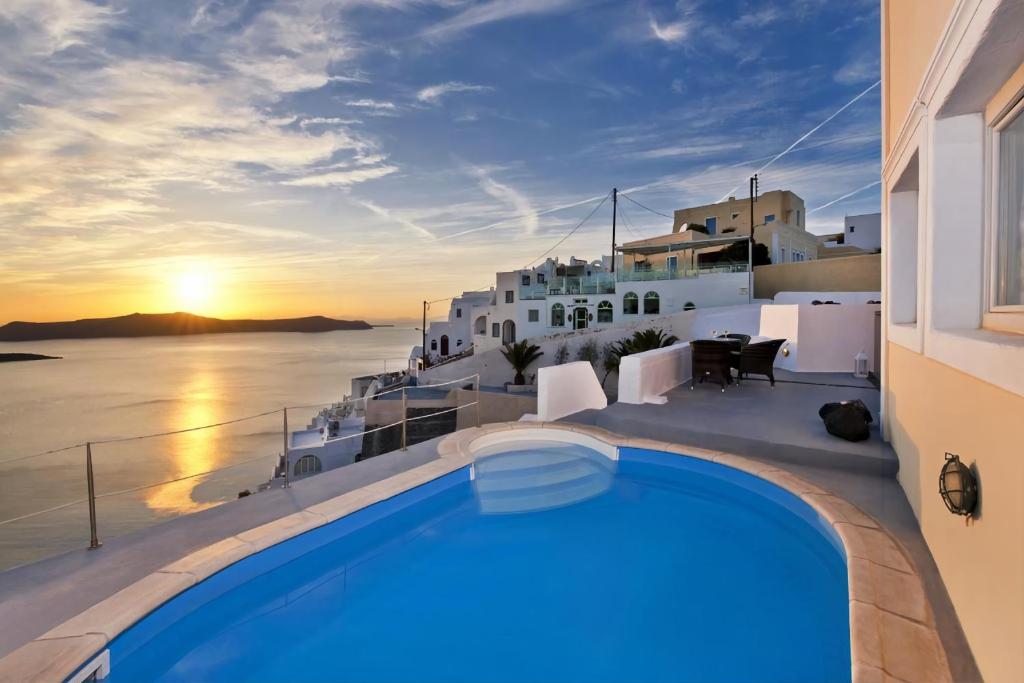 a pool on a house with a view of the ocean at NEOKLASSIKO KOUKOULI in Fira