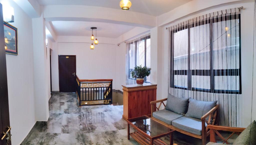 a living room with a chair and a window at Hotel Yangbum in Gangtok