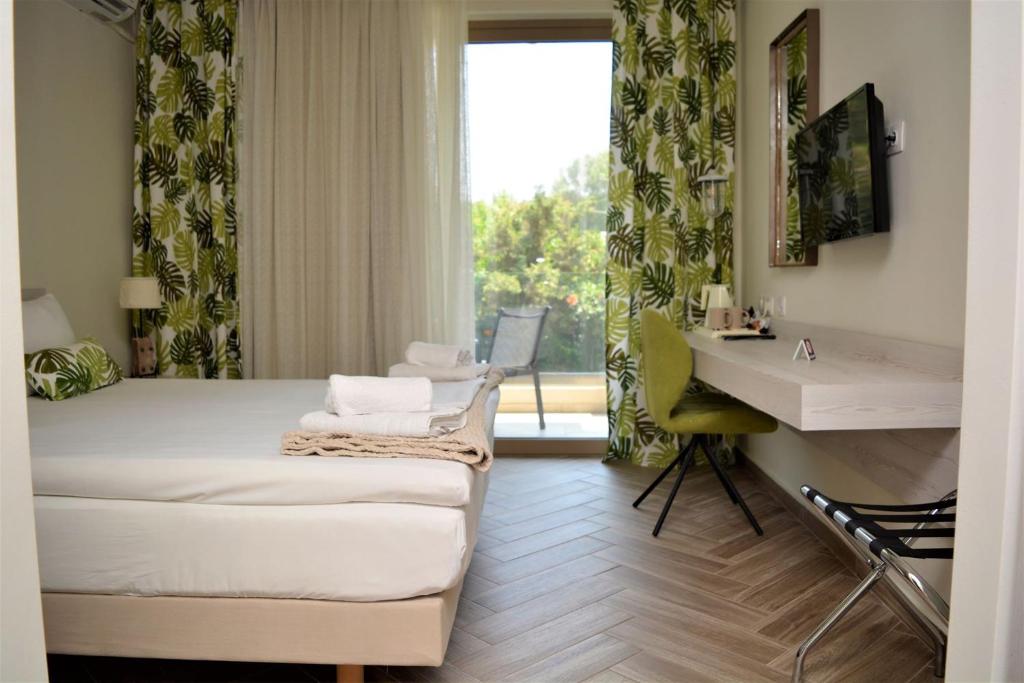 a hotel room with a bed and a sink and a window at The Archontariki in Ormos Panagias