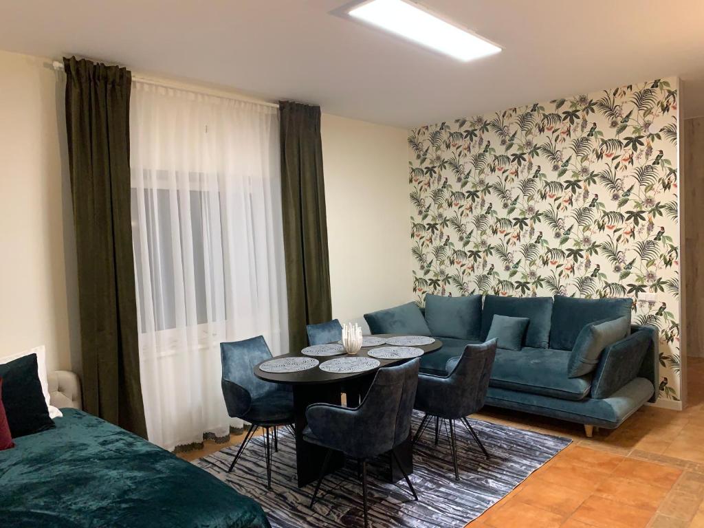 a living room with a couch and a table at Vila Renata Laure in Palanga