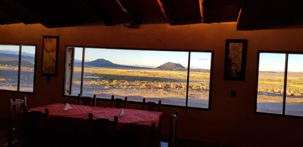 a dining room with a table and a view of the desert at Complejo Pucara in Antofagasta de la Sierra