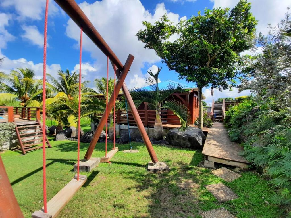a swing set in a park with a tree at Gite INDIA in Port-Louis