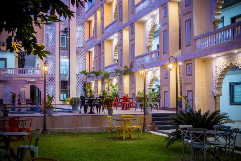 a courtyard of a building with tables and chairs at Hotel Pushkar City Inn in Pushkar