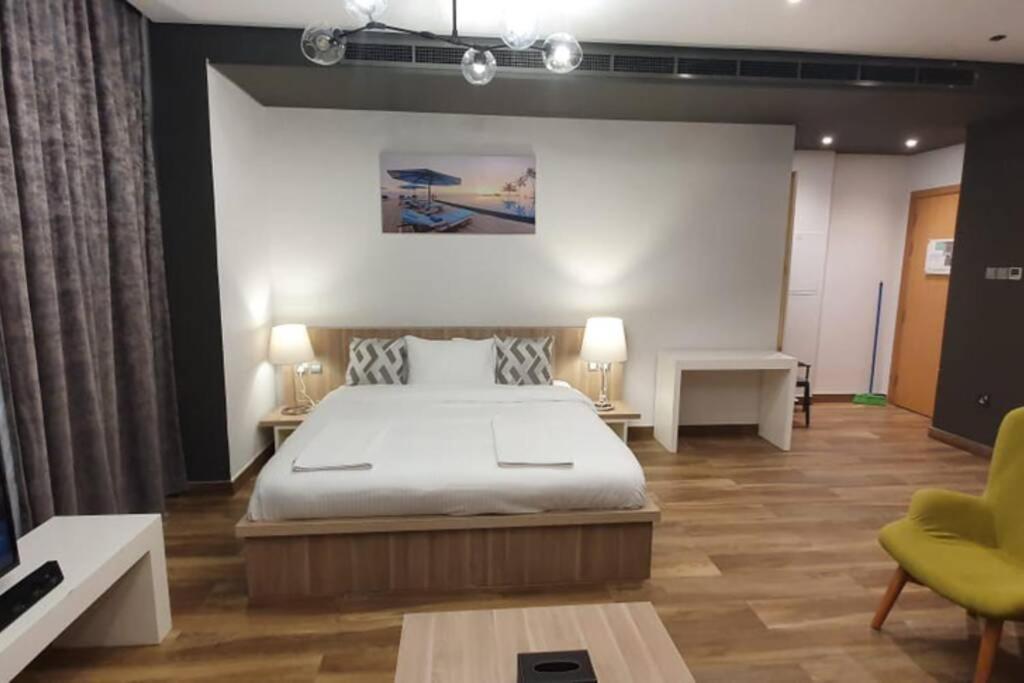 a bedroom with a bed and a couch and a table at Metro Access Cozy Furnished Studio at JBR walk in Dubai
