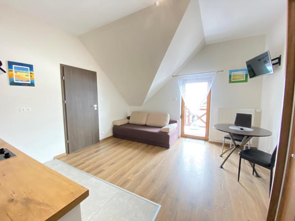 Televízia a/alebo spoločenská miestnosť v ubytovaní Dom Nad Brennica Pokoje i Apartamenty