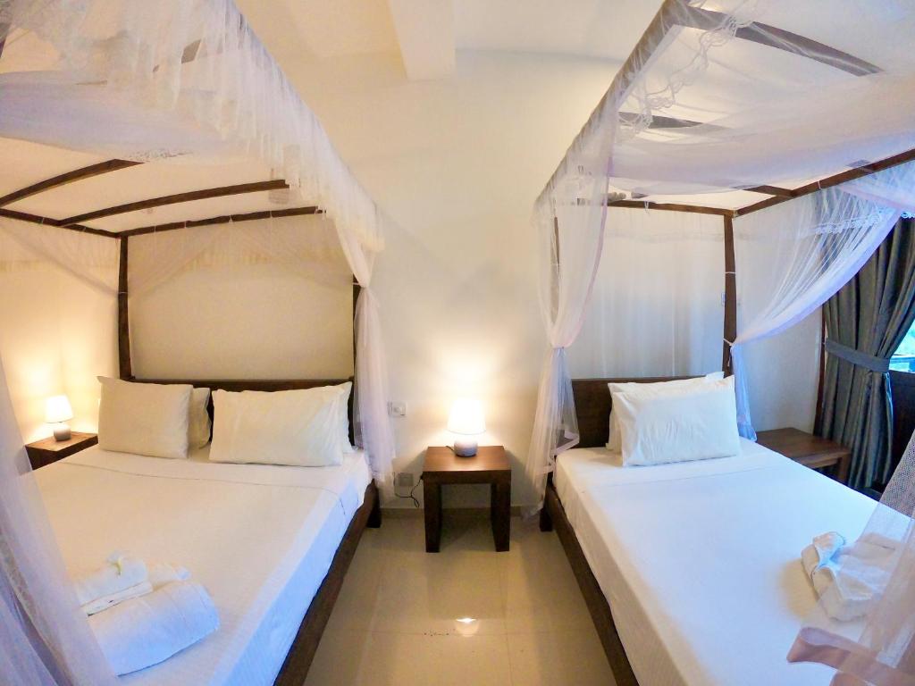 Postel nebo postele na pokoji v ubytování Kabalana Hotel & Villa