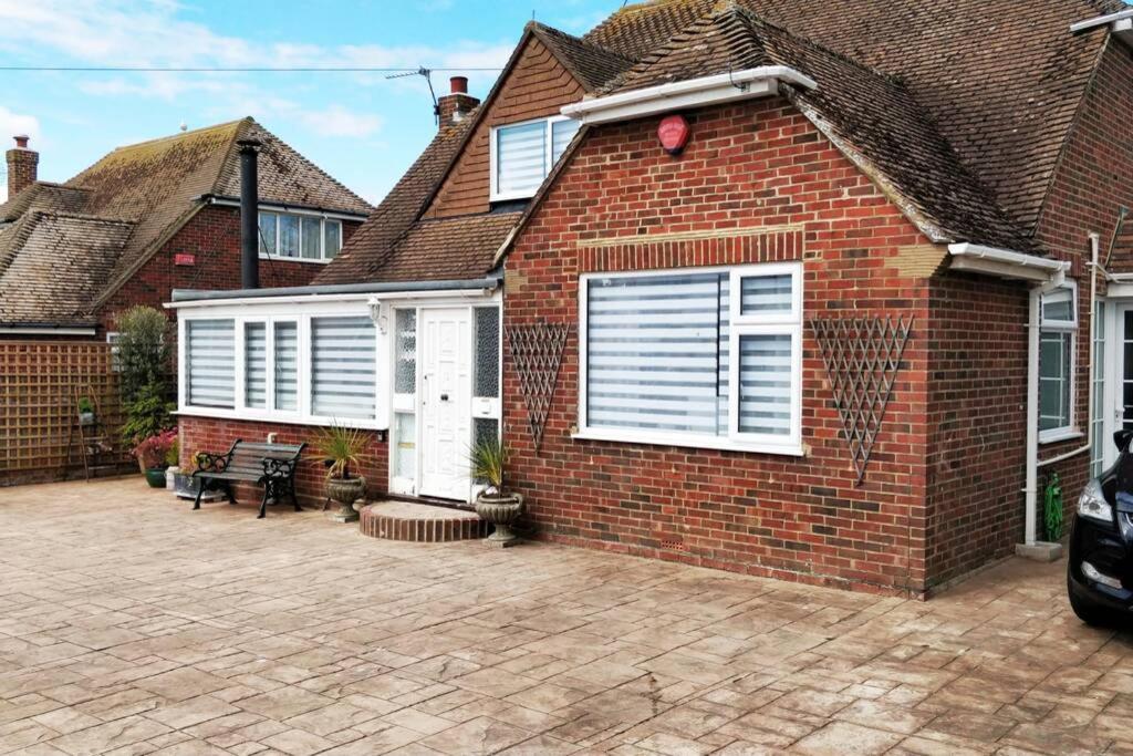 a brick house with a patio in front of it at Seven Seas Beach Retreat Studio Flat in Birchington