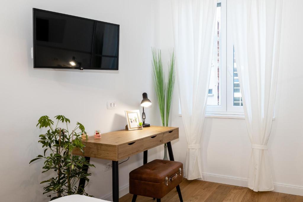 Televízia a/alebo spoločenská miestnosť v ubytovaní Aurelia Residence