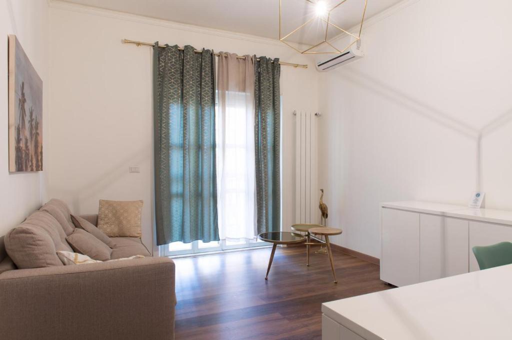 リド・ディ・オスティアにあるOstia Holiday Libertyのソファとテーブルのあるリビングルーム