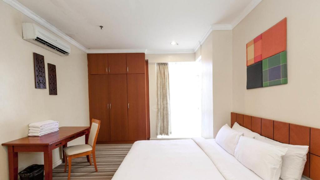 Ένα ή περισσότερα κρεβάτια σε δωμάτιο στο StayInn Gateway Hotel Apartment