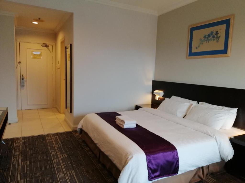 Ένα ή περισσότερα κρεβάτια σε δωμάτιο στο StayInn Gateway Hotel Apartment