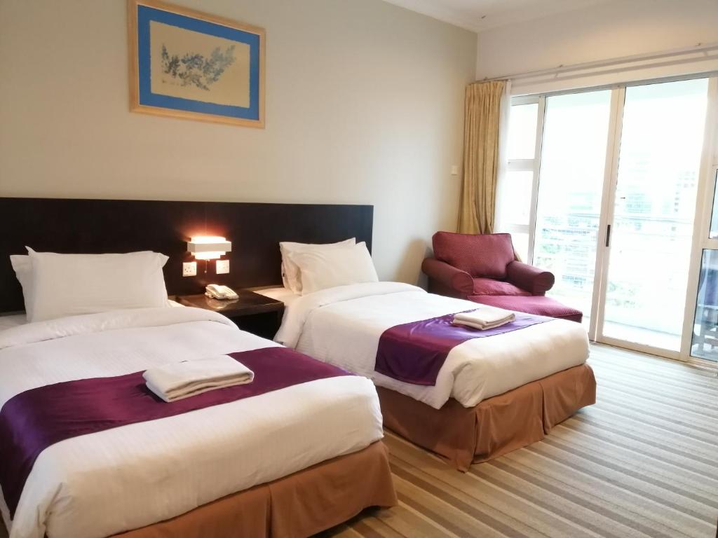 Ένα ή περισσότερα κρεβάτια σε δωμάτιο στο StayInn Gateway Hotel Apartment