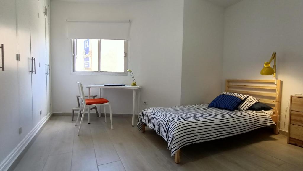 A bed or beds in a room at Alquilaencanarias- Medano Beach Tarajal
