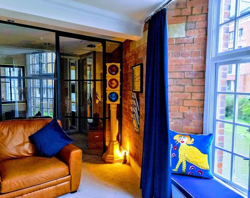 a living room with a couch and a window at Cocoa Isabella - River fronted with secure parking in York