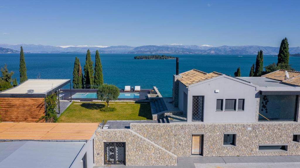 a house with a view of the water at Villa BLUELINE in Alykes Potamou
