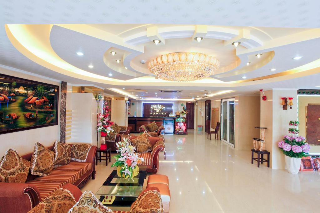 a lobby with couches and a chandelier at Linh Phuong 3 Hotel in Can Tho