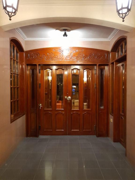 a hallway with wooden doors in a house at HOTEL PORTAL DE SALTA in Salta