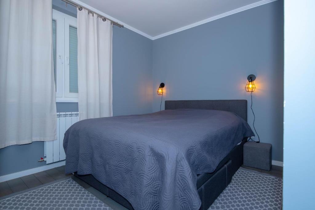 Postel nebo postele na pokoji v ubytování Athena Apartman