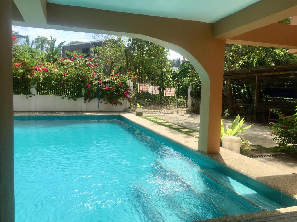 a swimming pool in the middle of a house at Larosa Hostel Bed and Breakfast in Puerto Princesa City