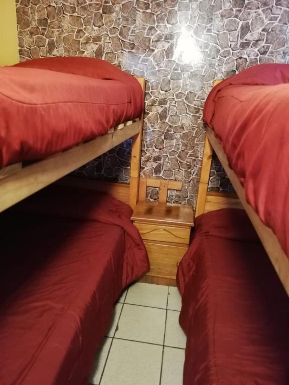 Postel nebo postele na pokoji v ubytování Habitaciones y Apartamentos el Caleuche El Tabo