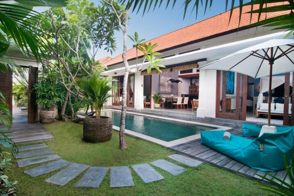 a villa with a swimming pool and a house at 2BR Villa Violetta - Minggu Villas in Kerobokan