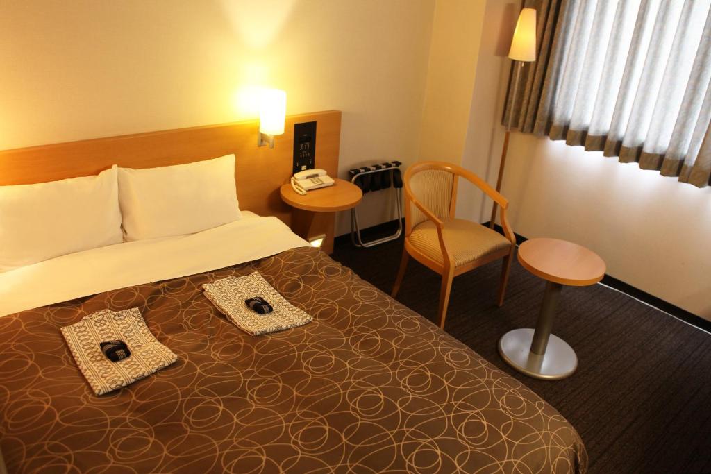 Postel nebo postele na pokoji v ubytování Hotel Ohta