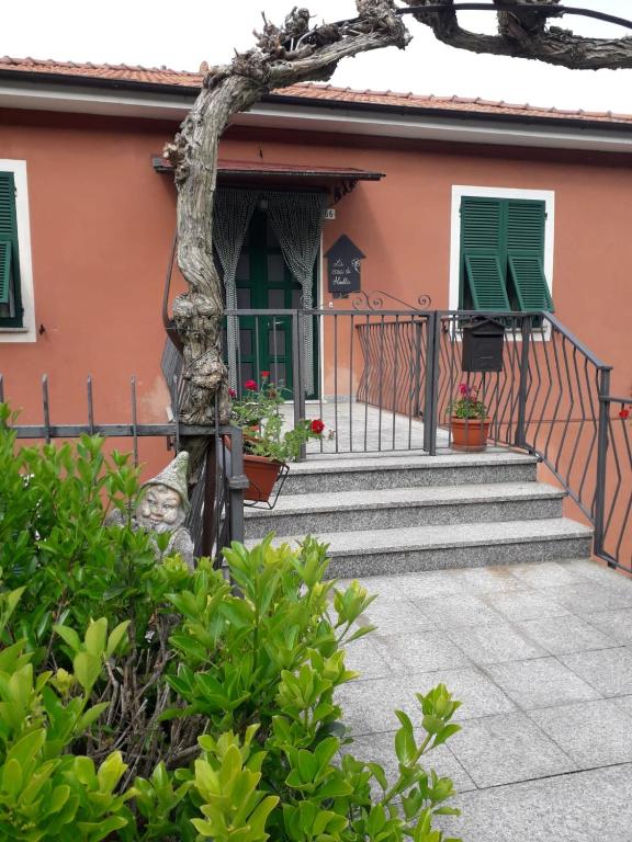 a house with stairs and green shutters at La casa di Mirella in Ne