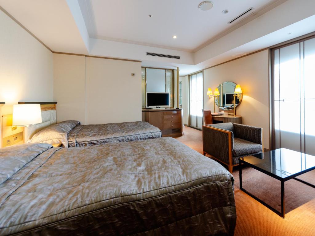 Postel nebo postele na pokoji v ubytování Hotel Crown Palais Kobe