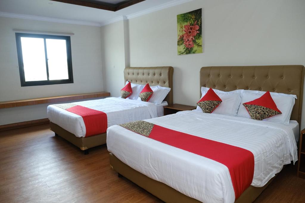 Postel nebo postele na pokoji v ubytování Joyful Hotel
