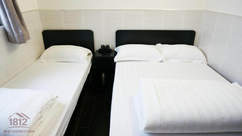 Postel nebo postele na pokoji v ubytování Kowloon Mongkok 1812 Guest House