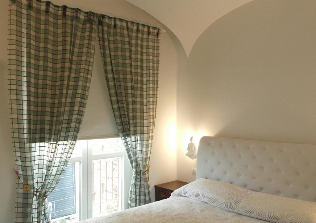 - une chambre avec un lit et une fenêtre avec des rideaux dans l'établissement Abracadabra Tortona, à Milan