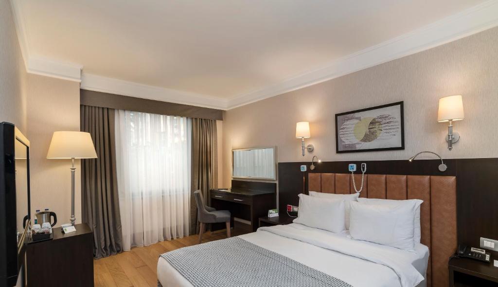 a hotel room with a bed and a piano at Holiday Inn Istanbul Old City by IHG in Istanbul