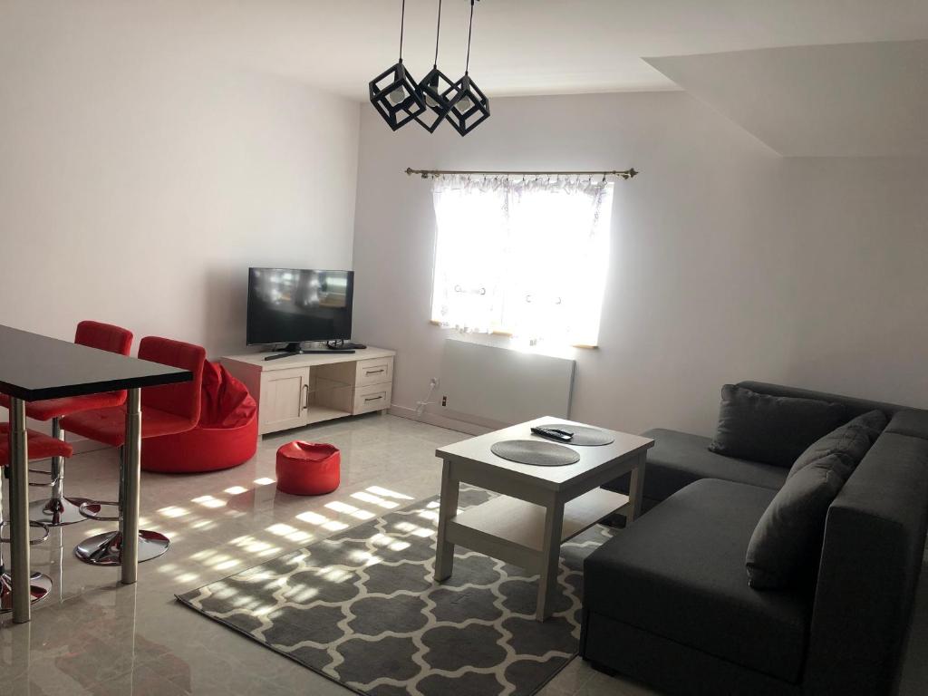 a living room with a couch and a table at Apartament Telkom 2 in Milówka