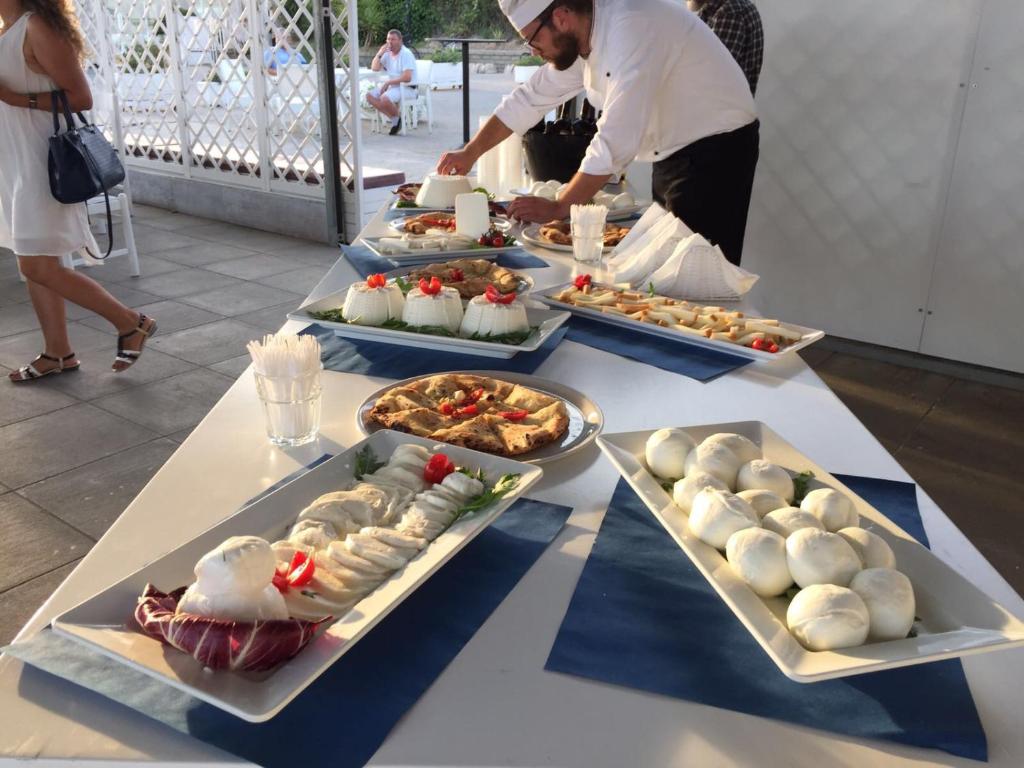 a table with several plates of food on it at Torre Del Sole in Terracina
