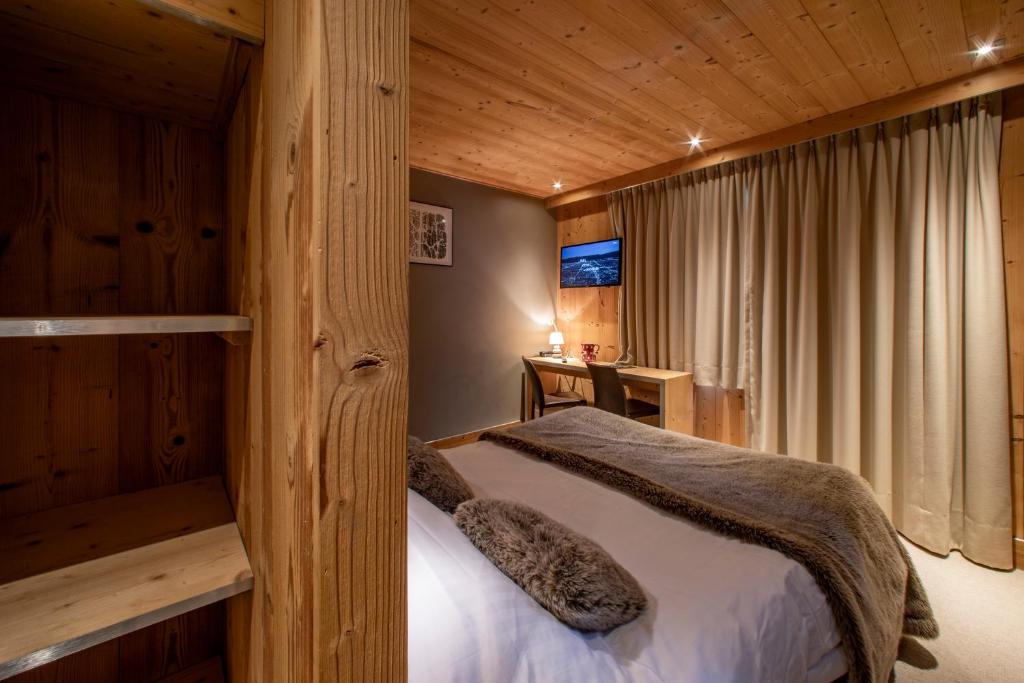 Postel nebo postele na pokoji v ubytování Chalet Les Rhodos