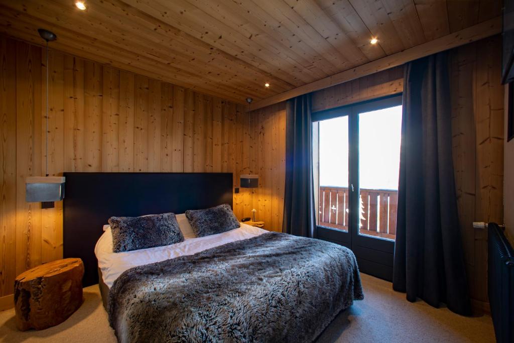 Postel nebo postele na pokoji v ubytování Chalet Les Rhodos