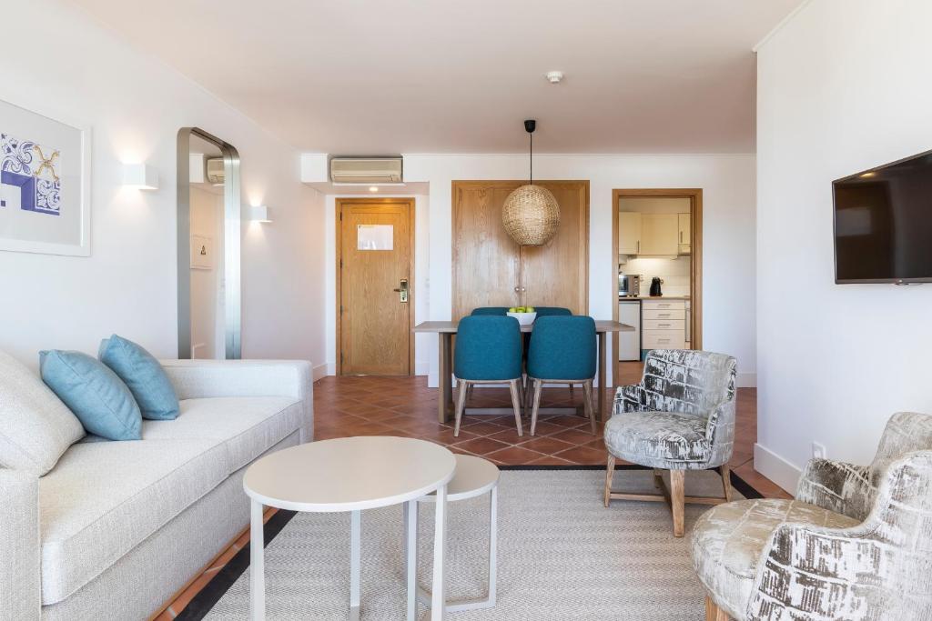 a living room with a couch and a table at The Patio Suite Hotel in Albufeira