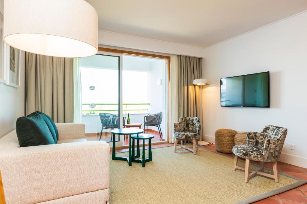 a living room with a couch and a table at The Patio Suite Hotel in Albufeira
