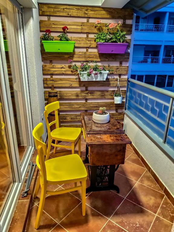 a table and chairs on a balcony with plants at Apartment INFINITY in Ohrid